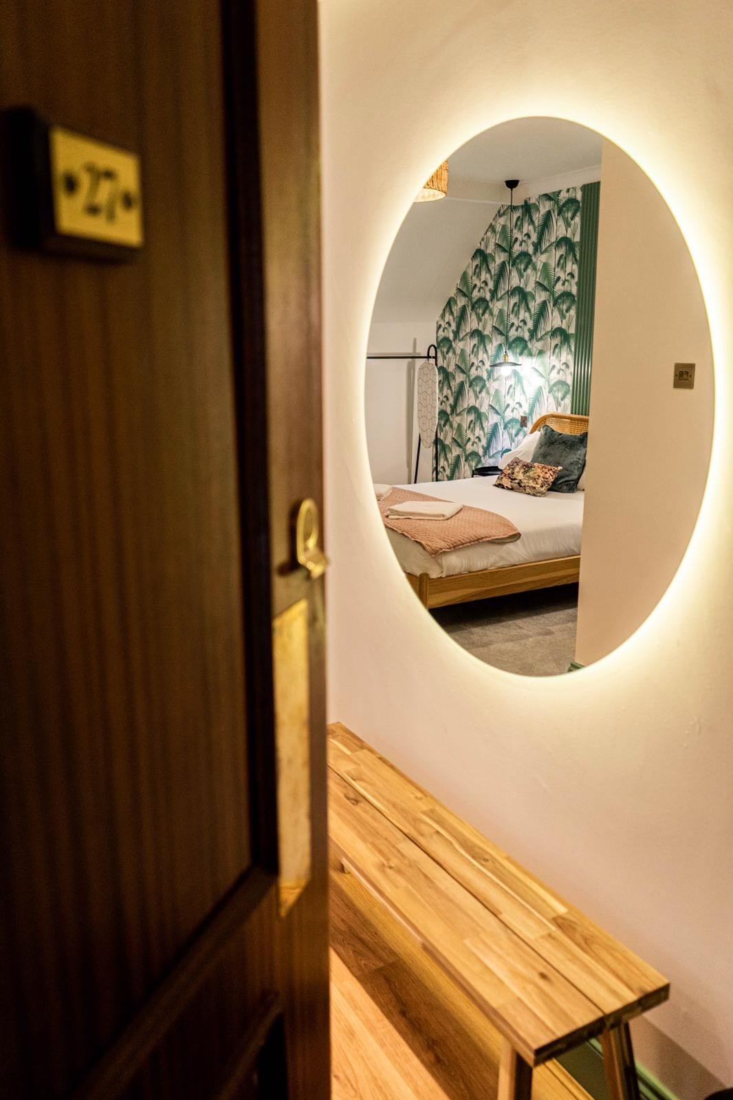 Jacobean Hotel room 27 doorway with backlit round mirror